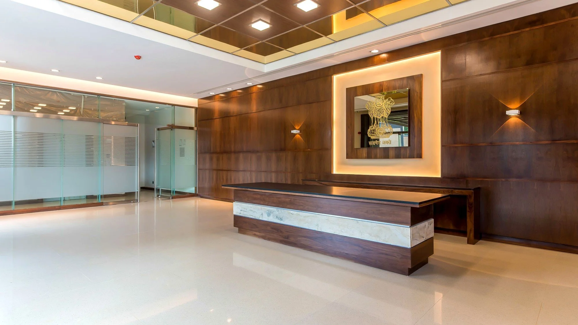 Chancery reception with timber panelling and the State Emblem of India.