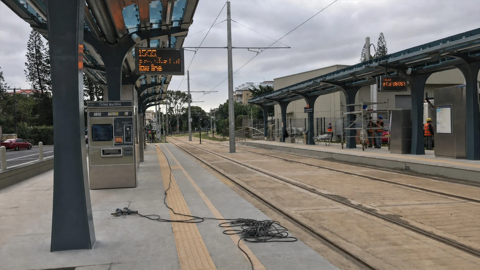 Metro Express station platform, tracks and overhead electrical infrastructure during construction-stage site activities in Mauritius.