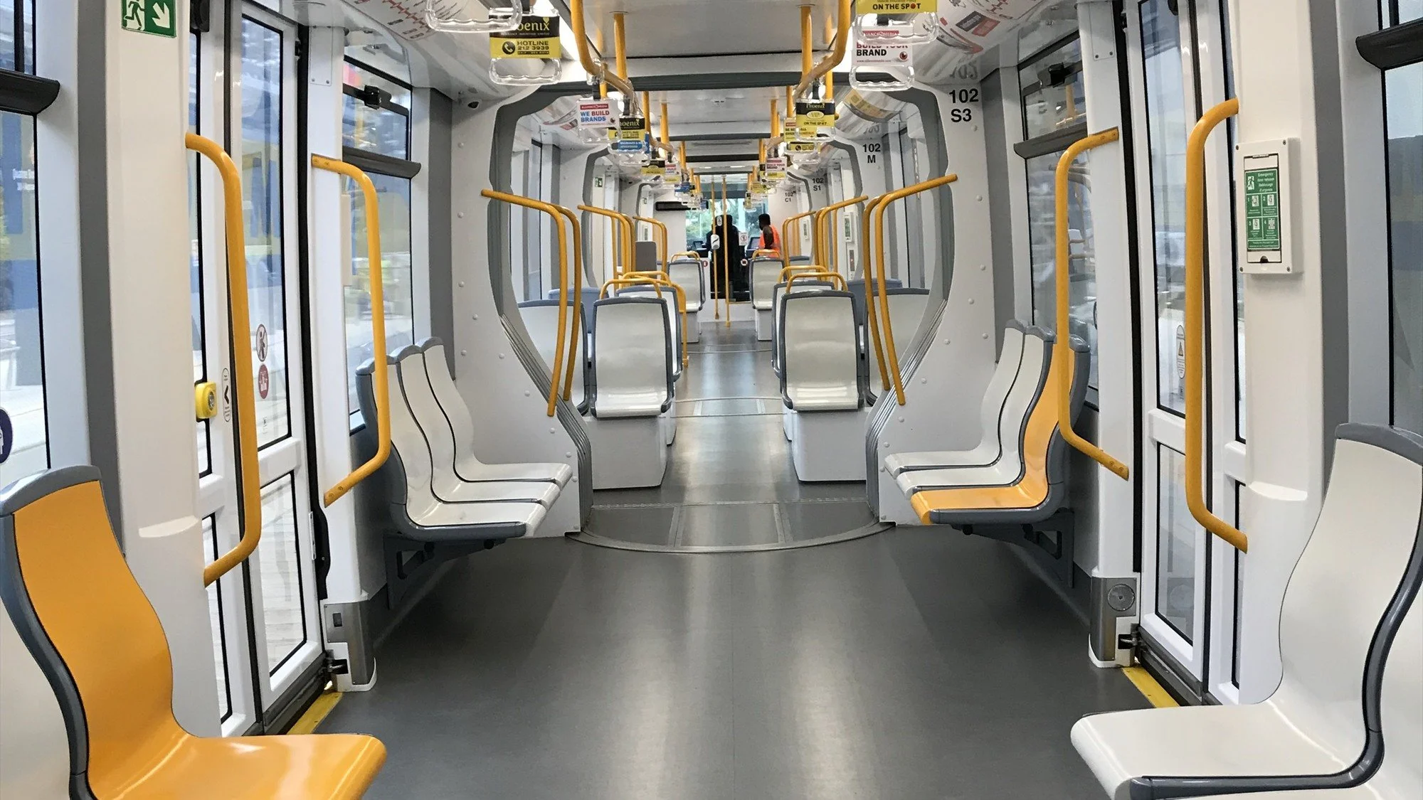 Interior of a Metro Express light rail vehicle showing passenger seating and accessible circulation space