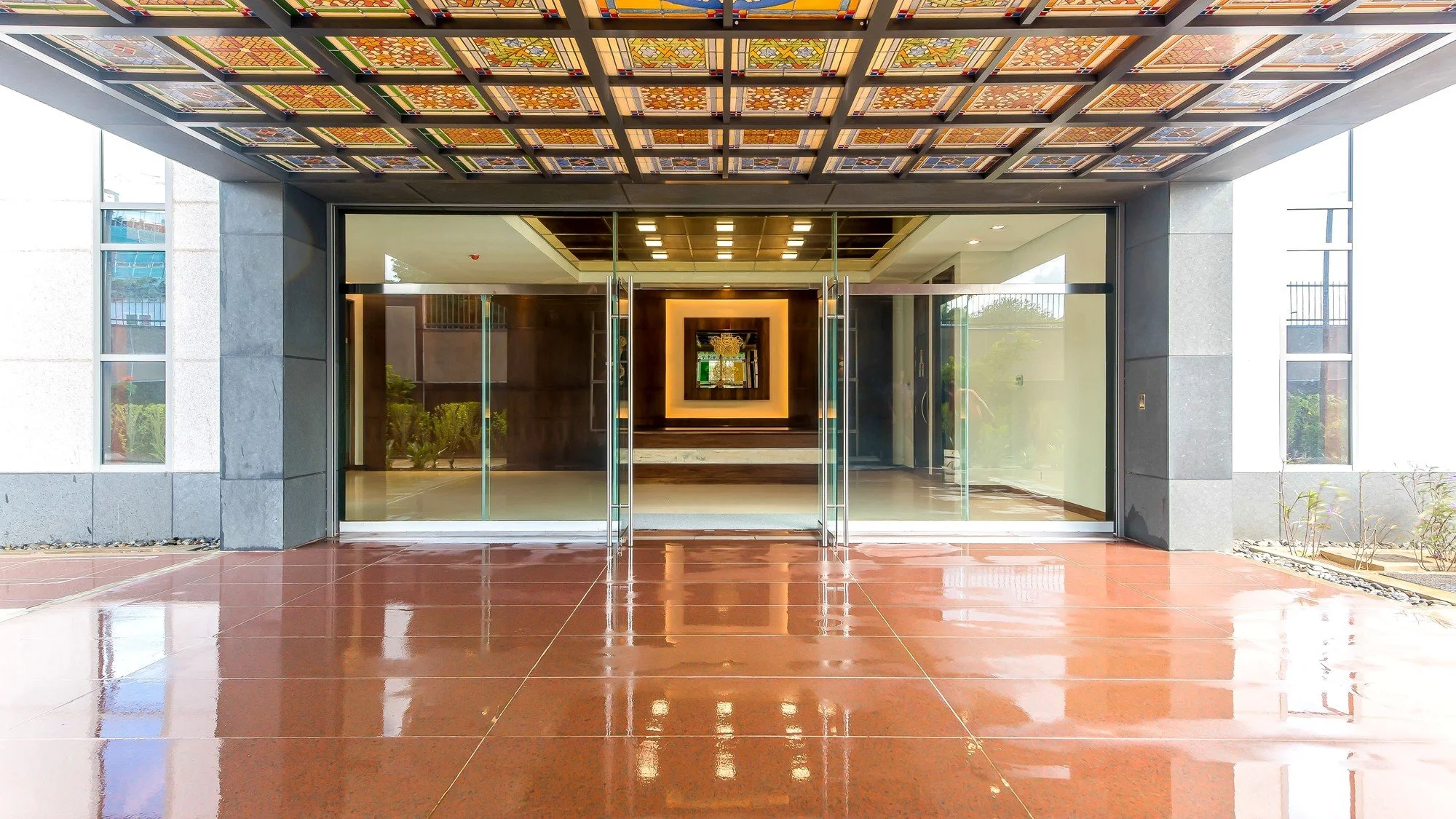Main entrance to the High Commission of India chancery beneath a stained-glass canopy