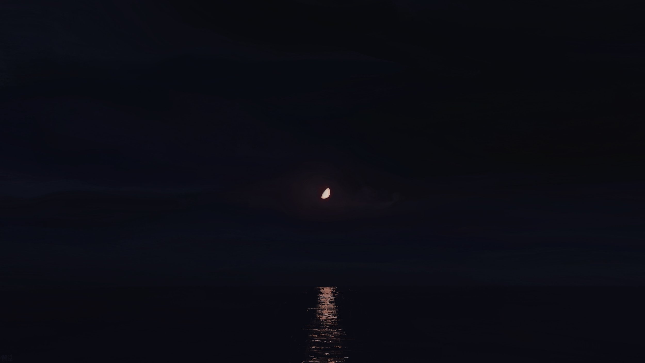 Digital painting: in a dark blue, cloudy night sky, a waxing gibbous moon is glowing above a large body of water. Its reflection is broken up by small ripples in the water.