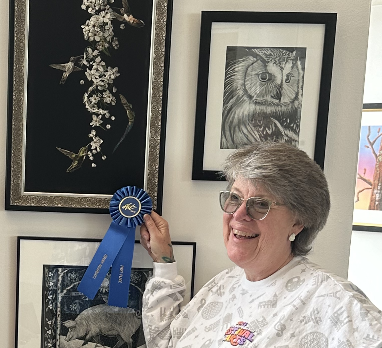 artist sally terrell stands in front of her award winning scratchboard artwork