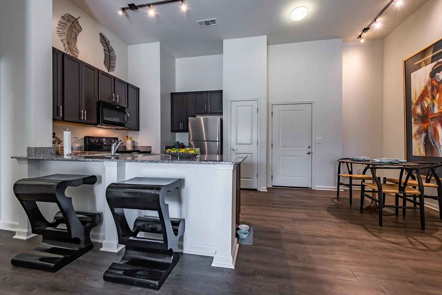 The apartments at the Meridian at Fondren feature a bright open-concept layout and a stylish, well-appointed kitchen with sleek countertops and full-size appliances.