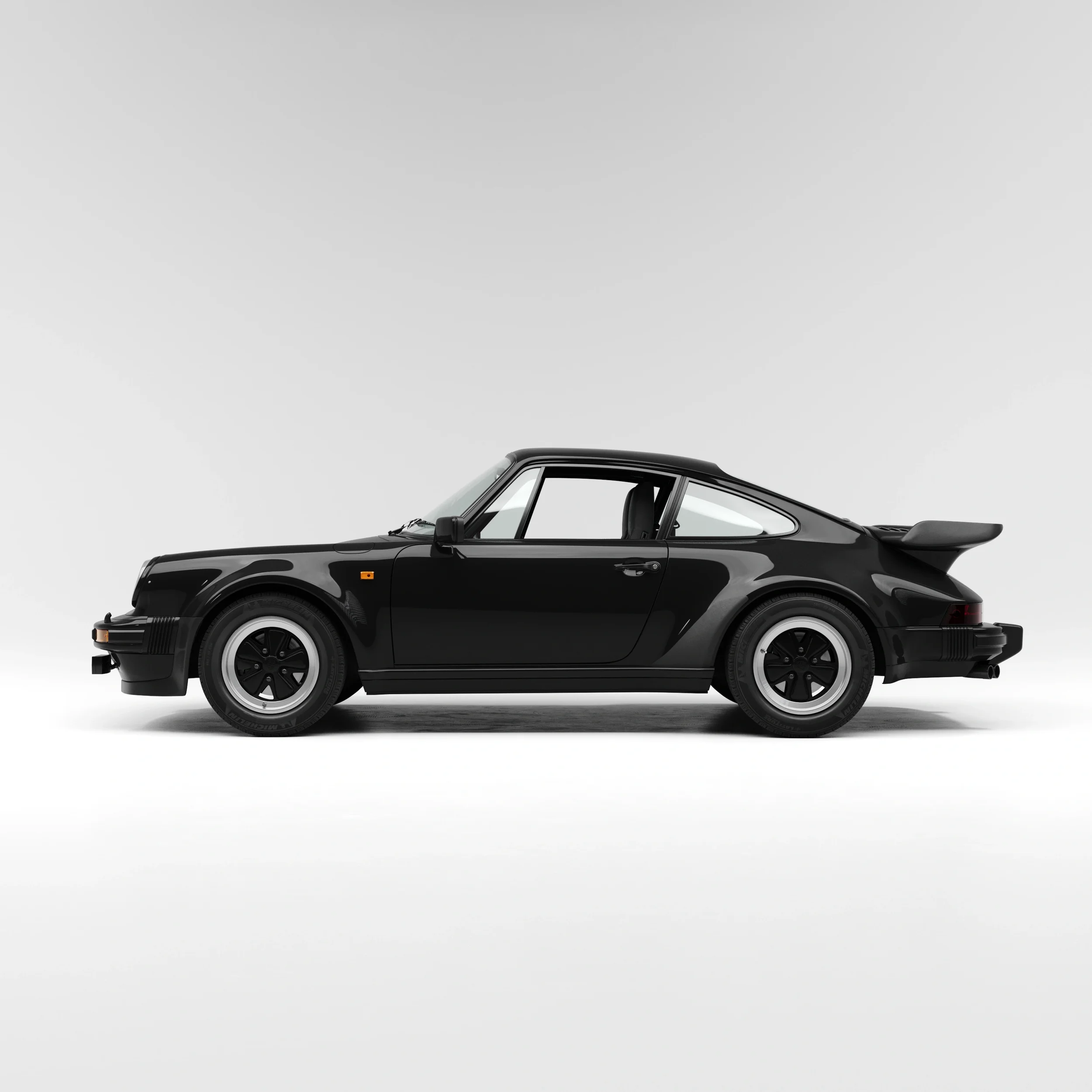 Black Porsche 930 Turbo coupe in studio, front three-quarter view with classic widebody and rear wing
