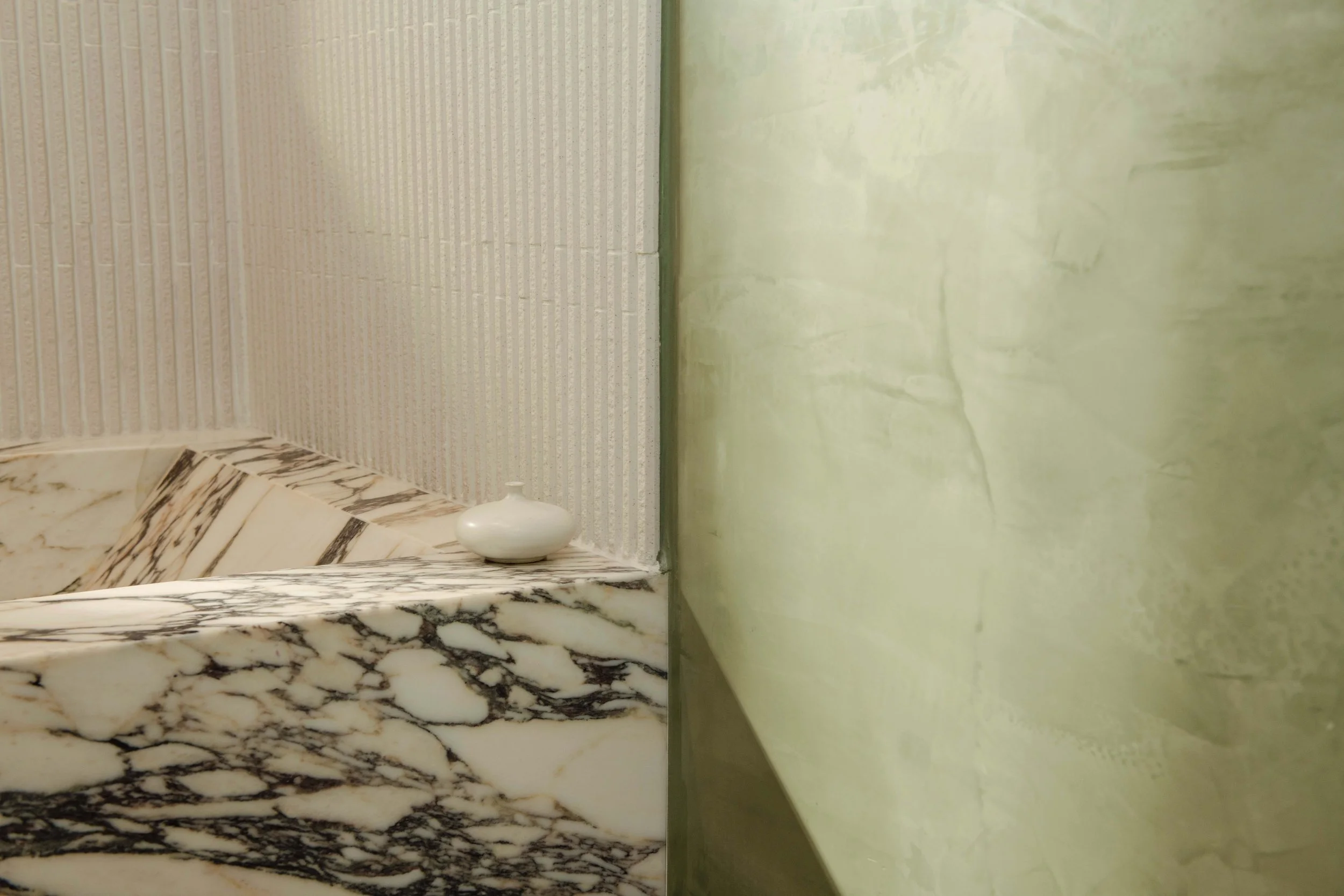Lavell Drive — bathroom with Calacatta Monet bathtub, green roman clay walls and a reeded glass window