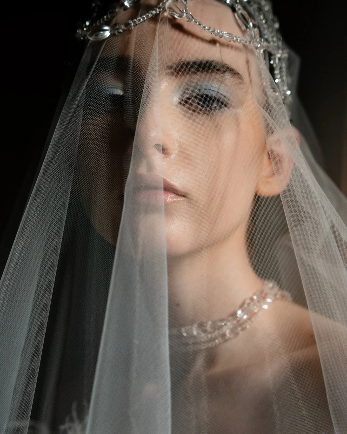 Evangelina 

An ethereal, spellbound moment shaped by soft light and a sheer veil. I rarely work with artificial light, but this experience felt like stepping into a fairytale&mdash;an elegant exploration that leans more editorial, more romantic, and