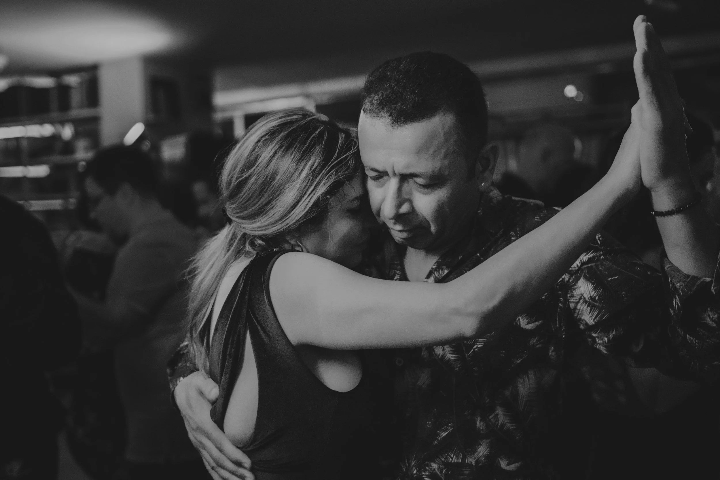 a black and white photo of a couple dancing