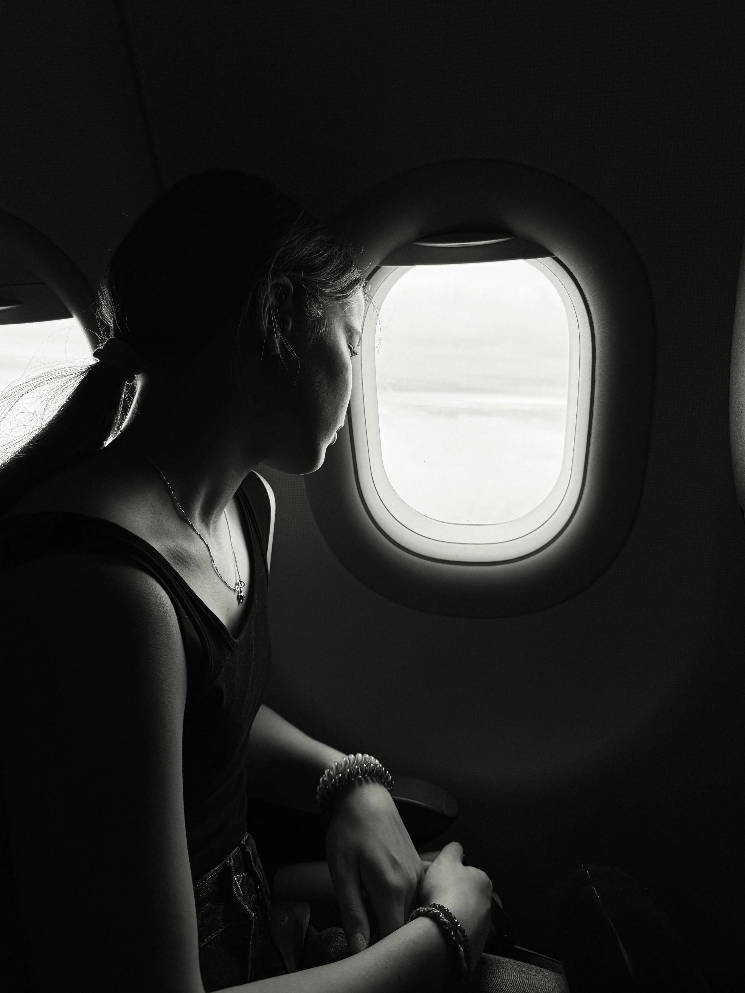 person looking trough an airplane window