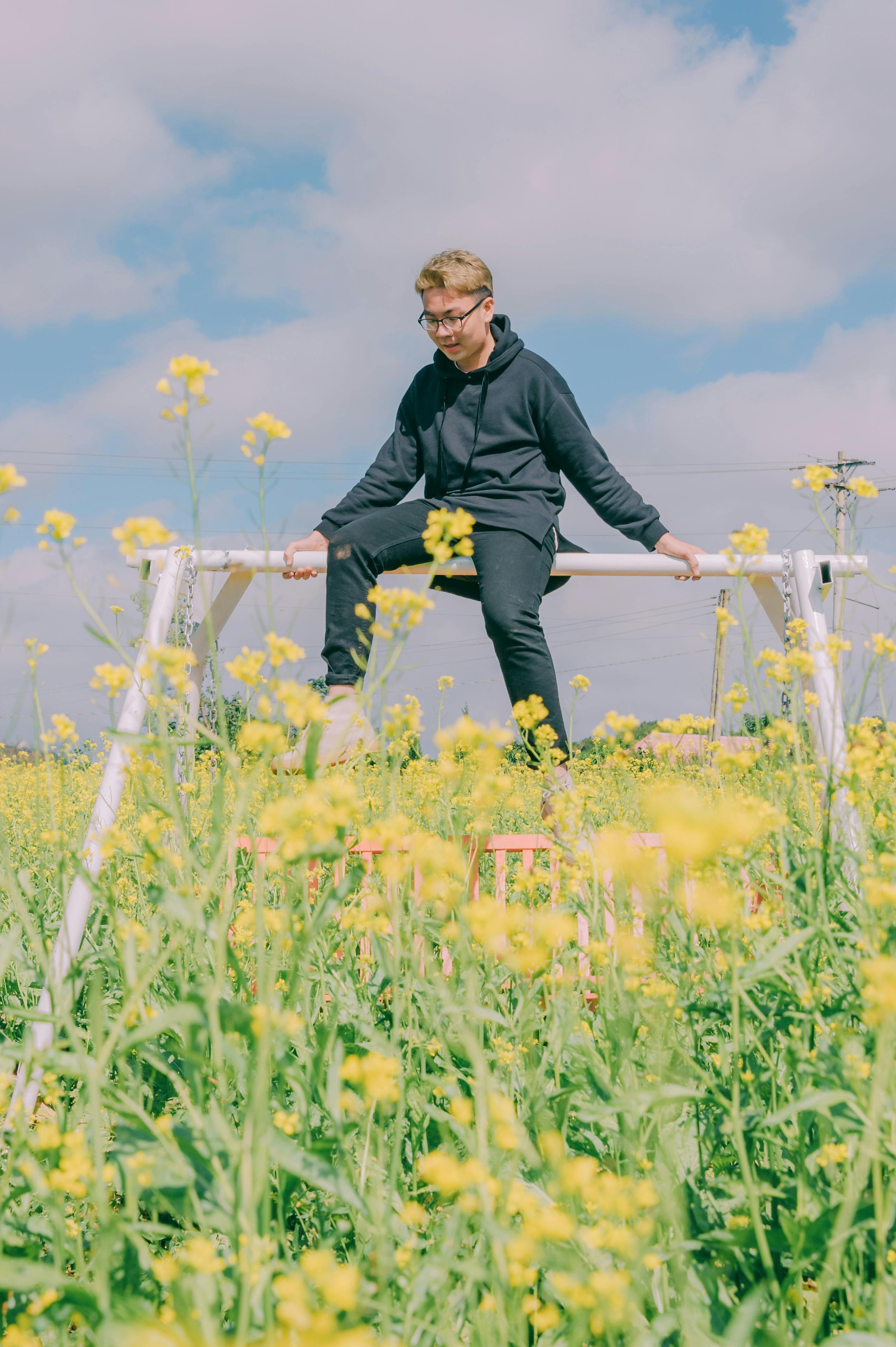 a person outdoors surrounded by flowers