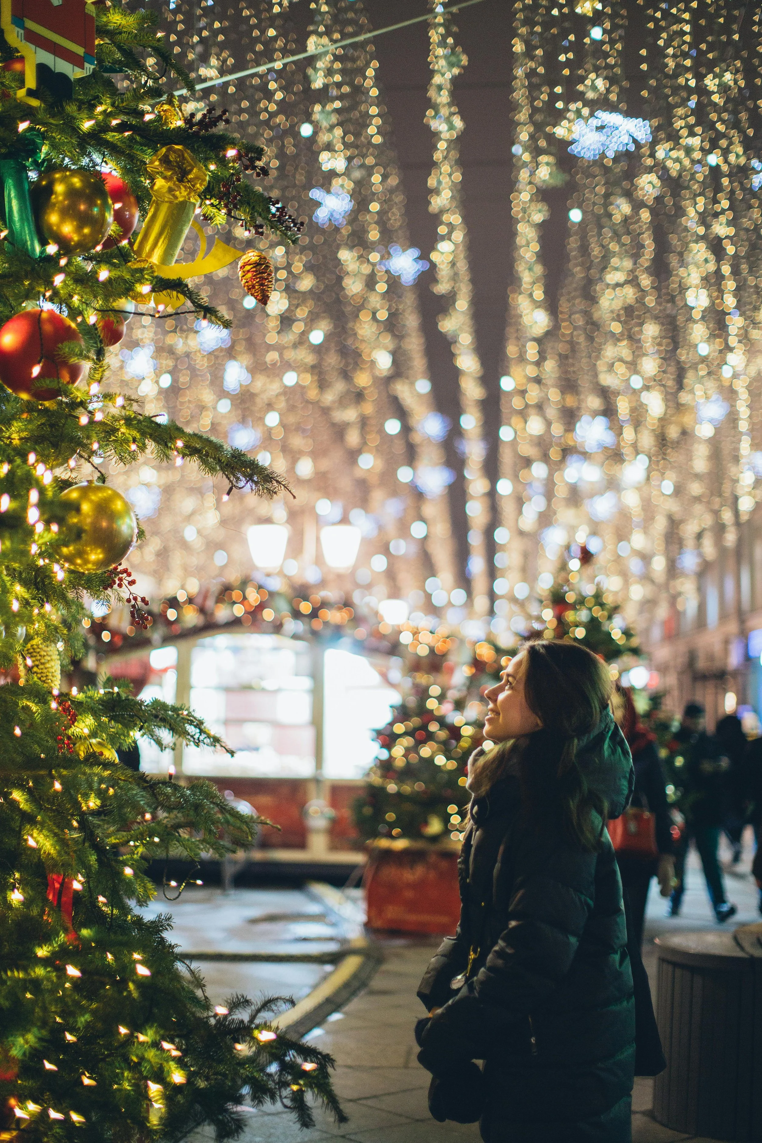 a person looking at a christmas tree