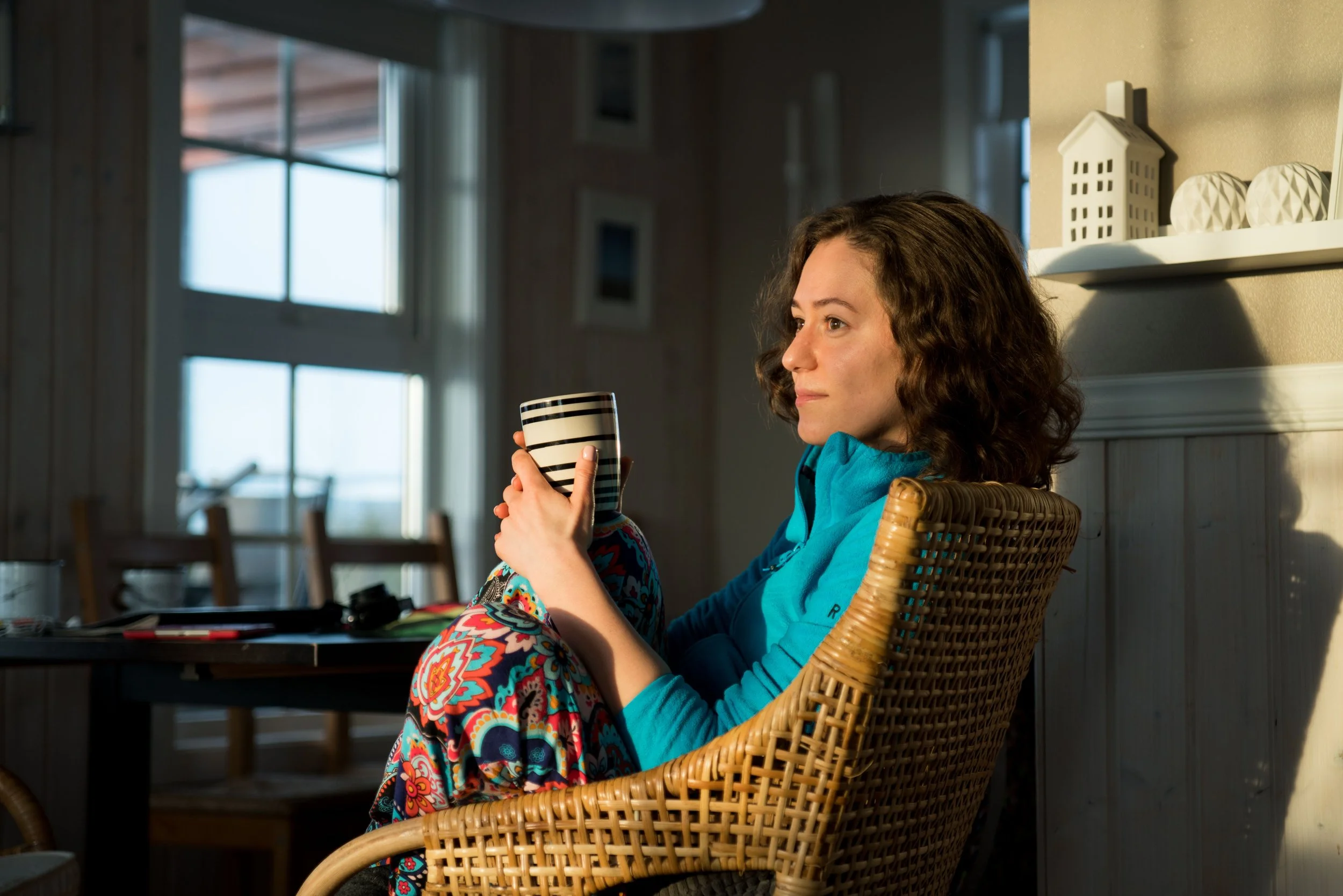 a person sitting down holding a mug