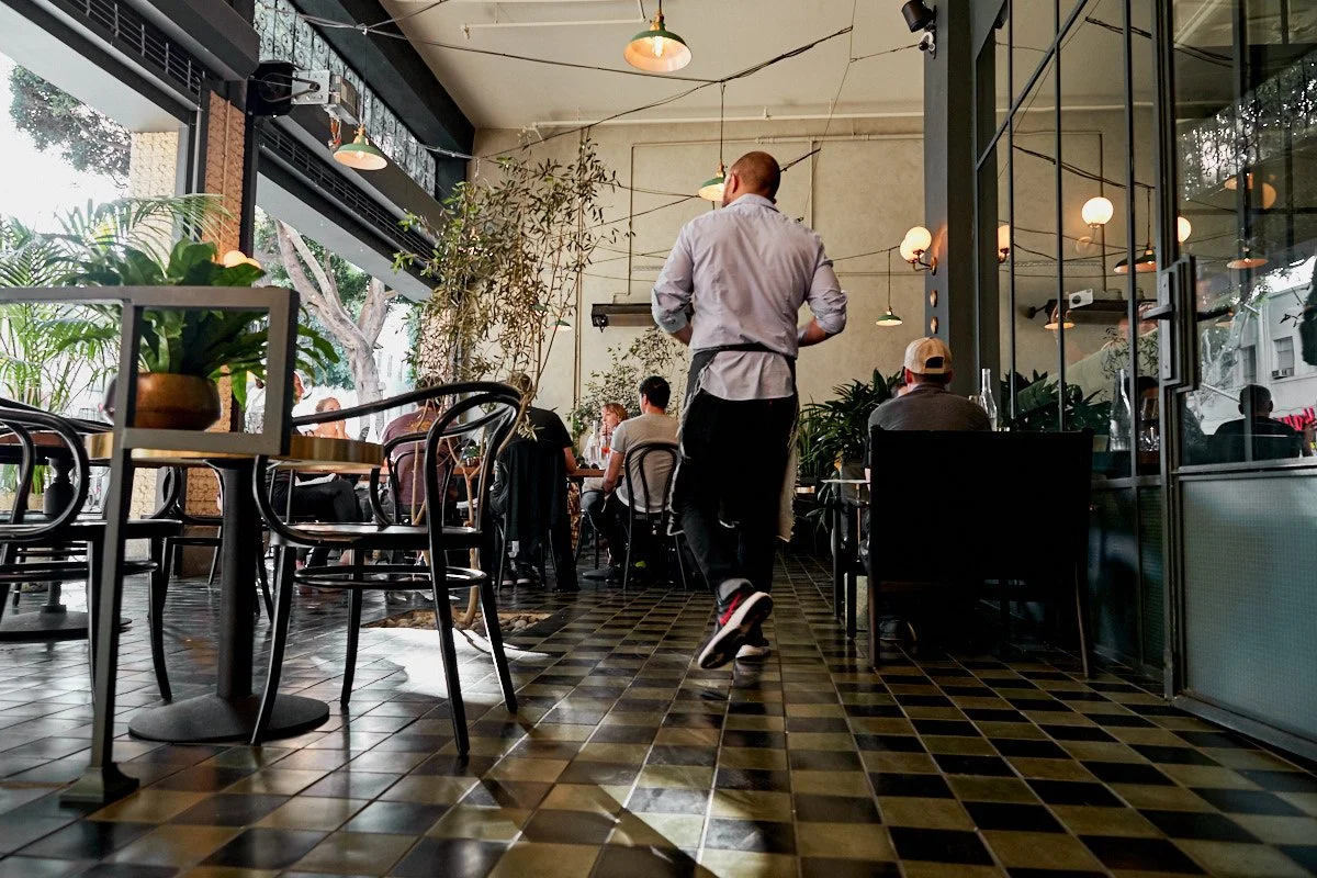 Photo of server on outdoor patio at Massilia, a French-Mediterranean restaurant