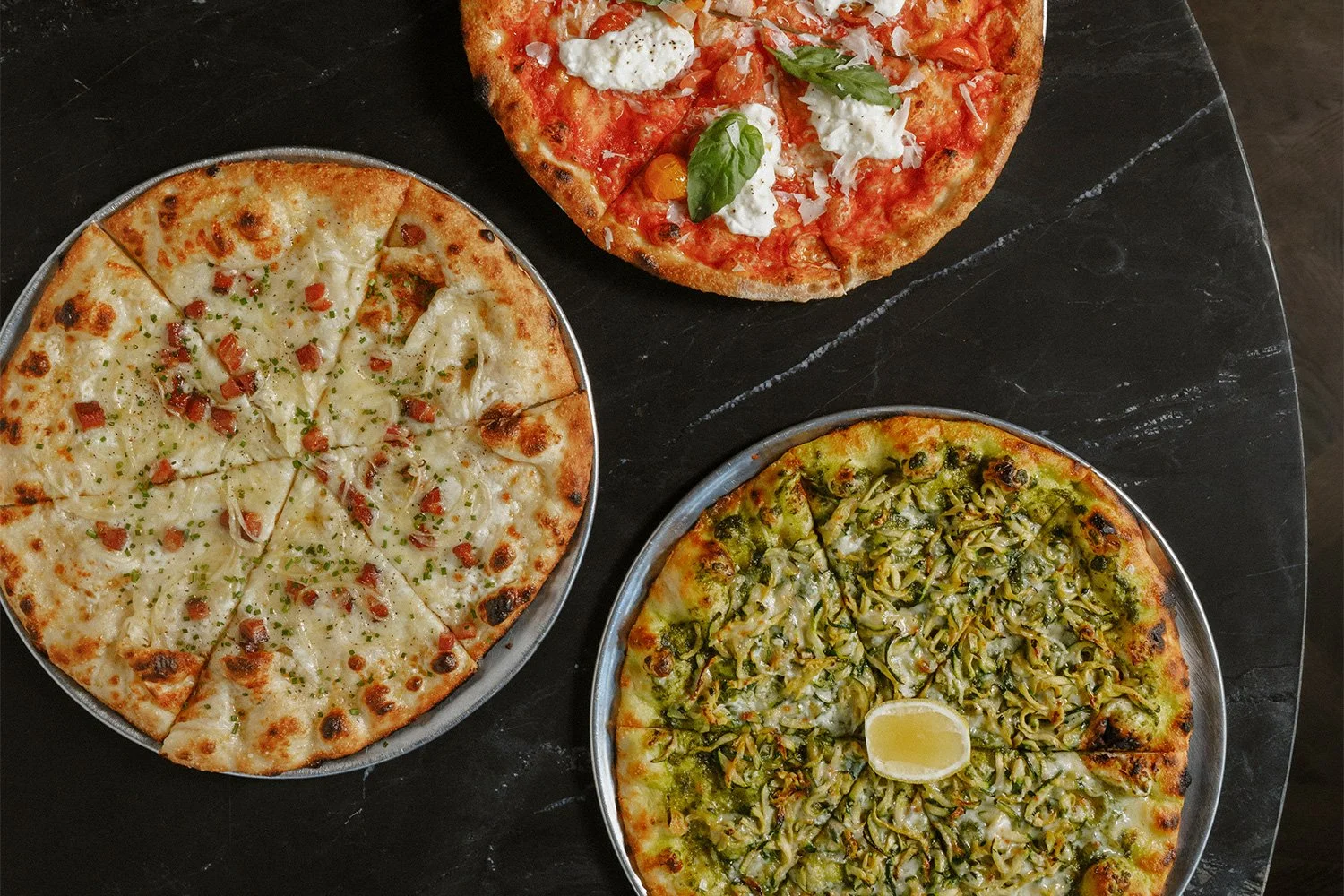 Photos of burrata margherita pizza, Tarte Flambée pizza & courgette pizza at Massilia, a French-Mediterranean restaurant