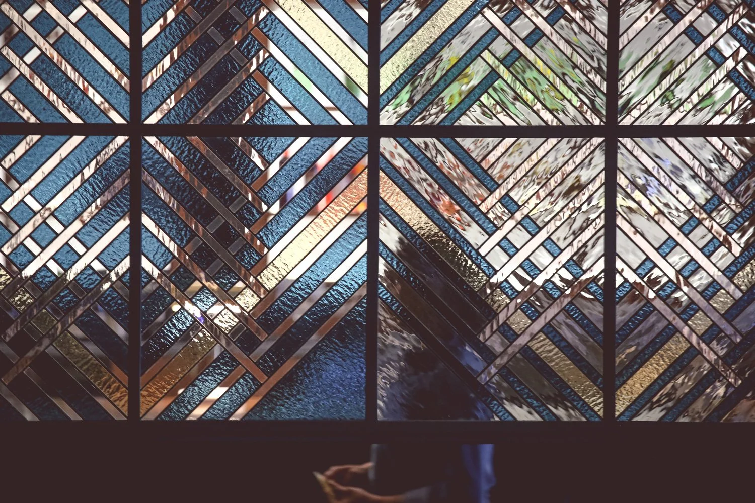 Photo of Woman Behind Stained Glass at Massilia