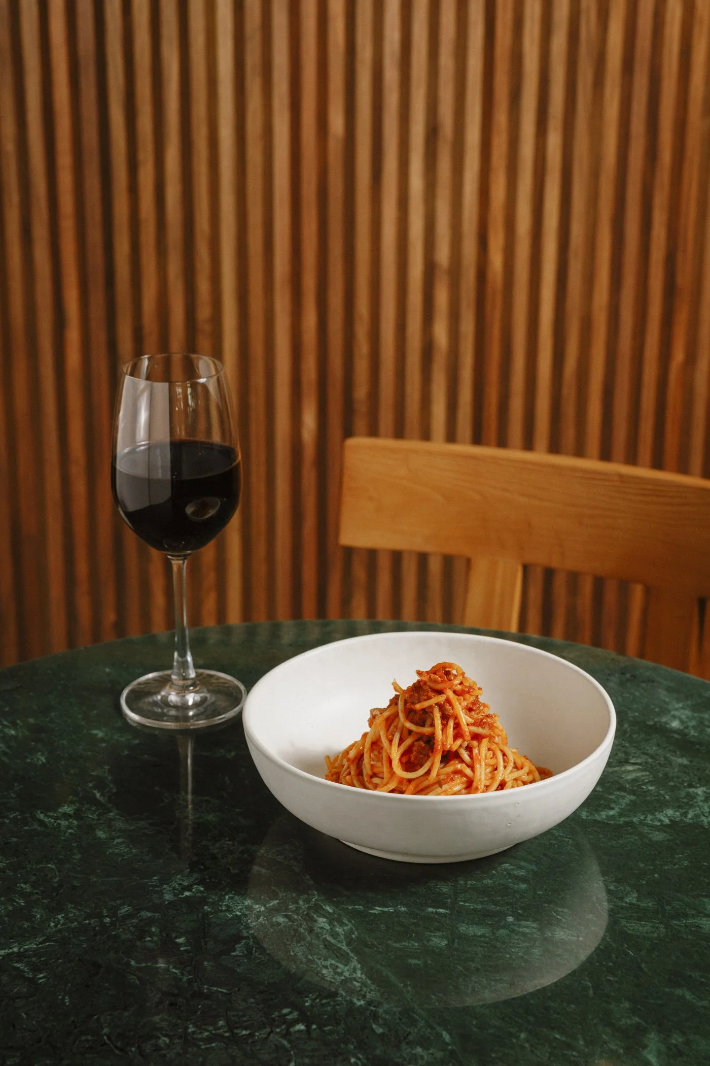 Photo of spaghetti bolognese with glass of wine at Massilia, a French-Mediterranean restaurant