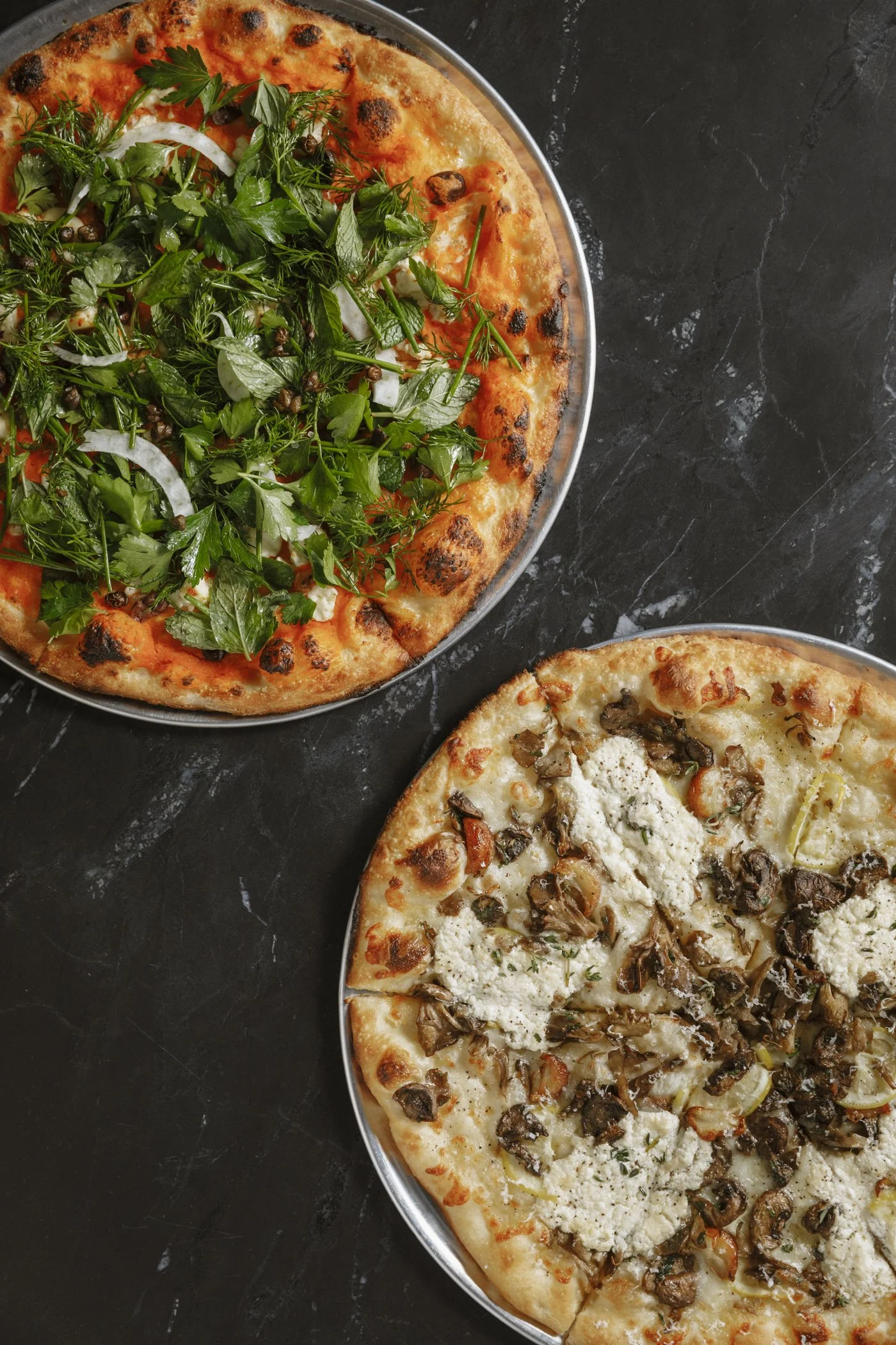 Photo of lablabi & noiçoise olives pizza & mushroom ricotta pizza at Massilia, a French-Mediterranean restaurant