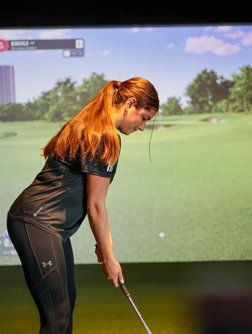 Golfer using simulator at Tee Box