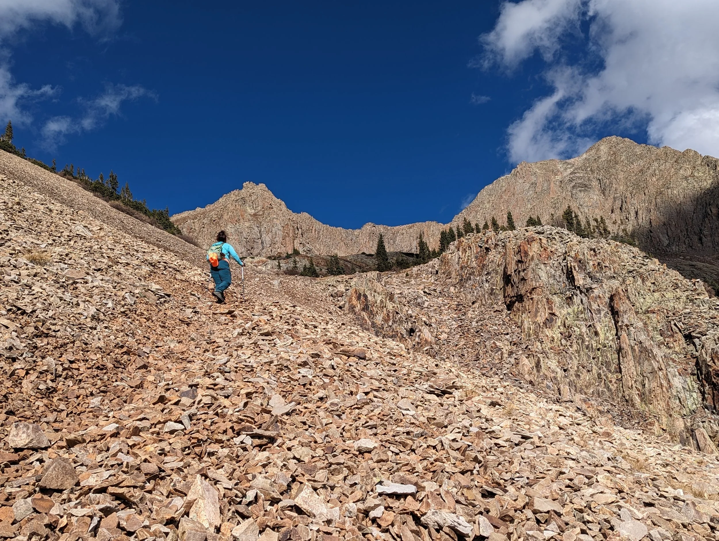 Regina ascending a social trail up a rock glacier