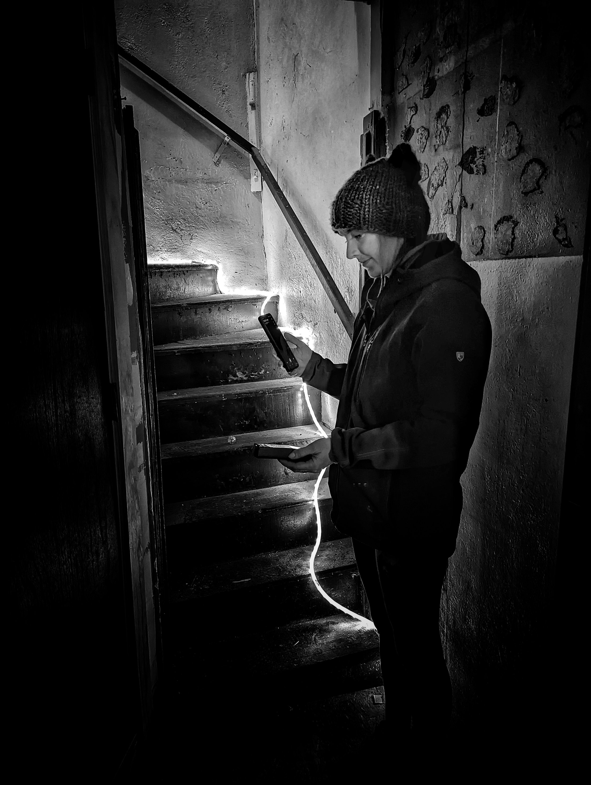 Kit taking a reading at the base of the stairs