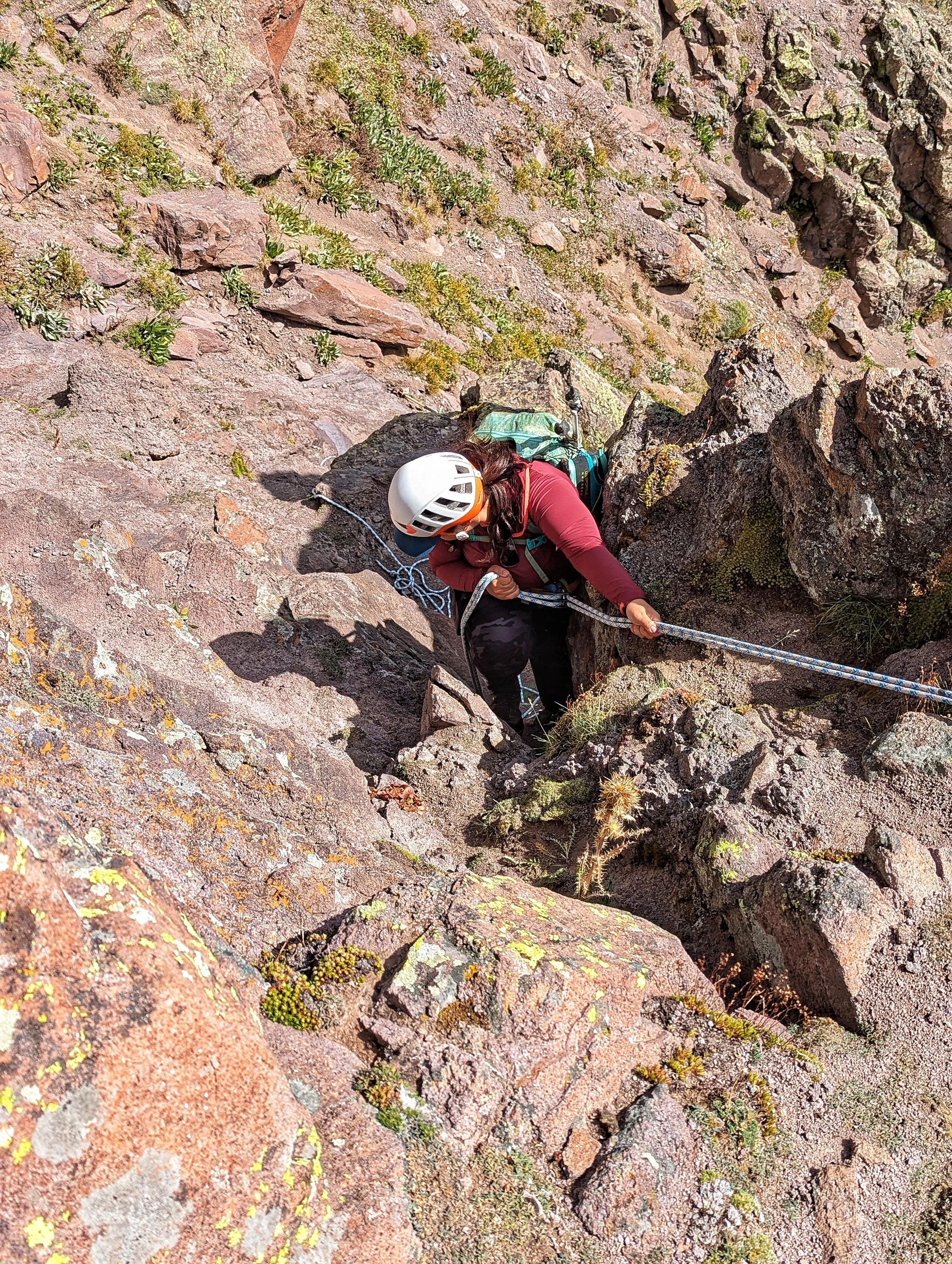 Regina rappelling past the access shelf