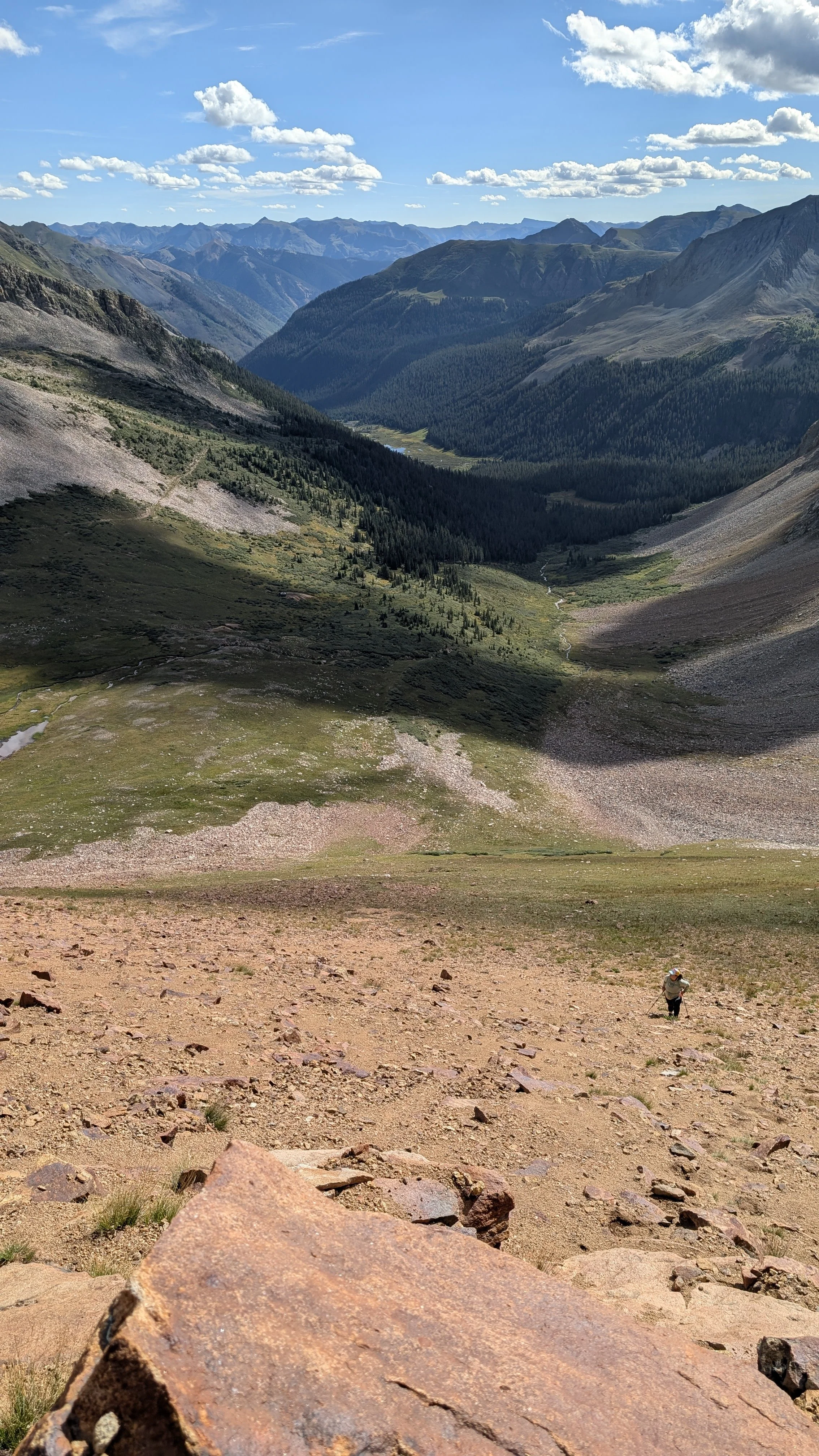 Nearing the cliffs. Regina trudging up the slope. 