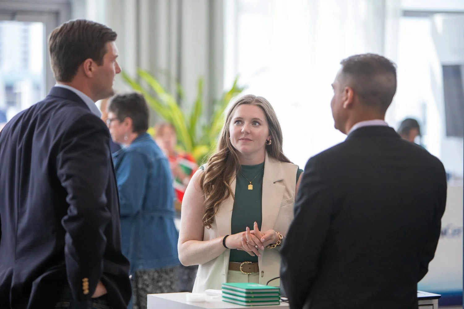 Attendees in conversation during a conference networking break, photographed by Big Wave Productions