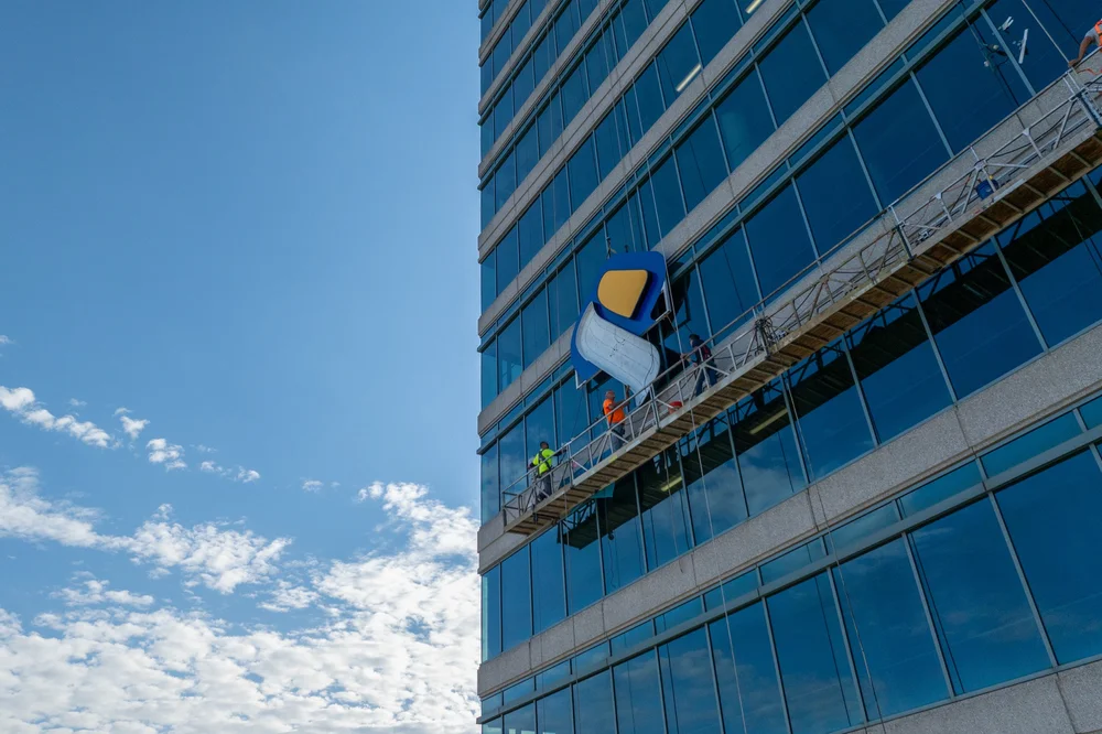 Crews installing SouthState signage on Atlanta’s Prominence Tower