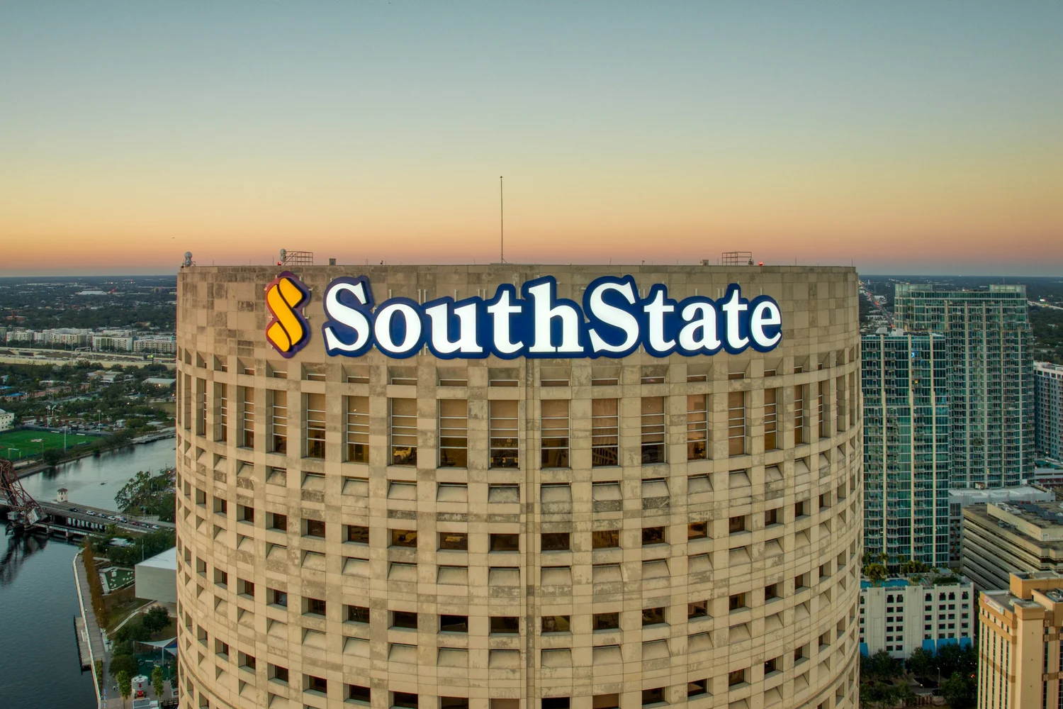 SouthState signage on Rivergate Tower above Tampa at sunset