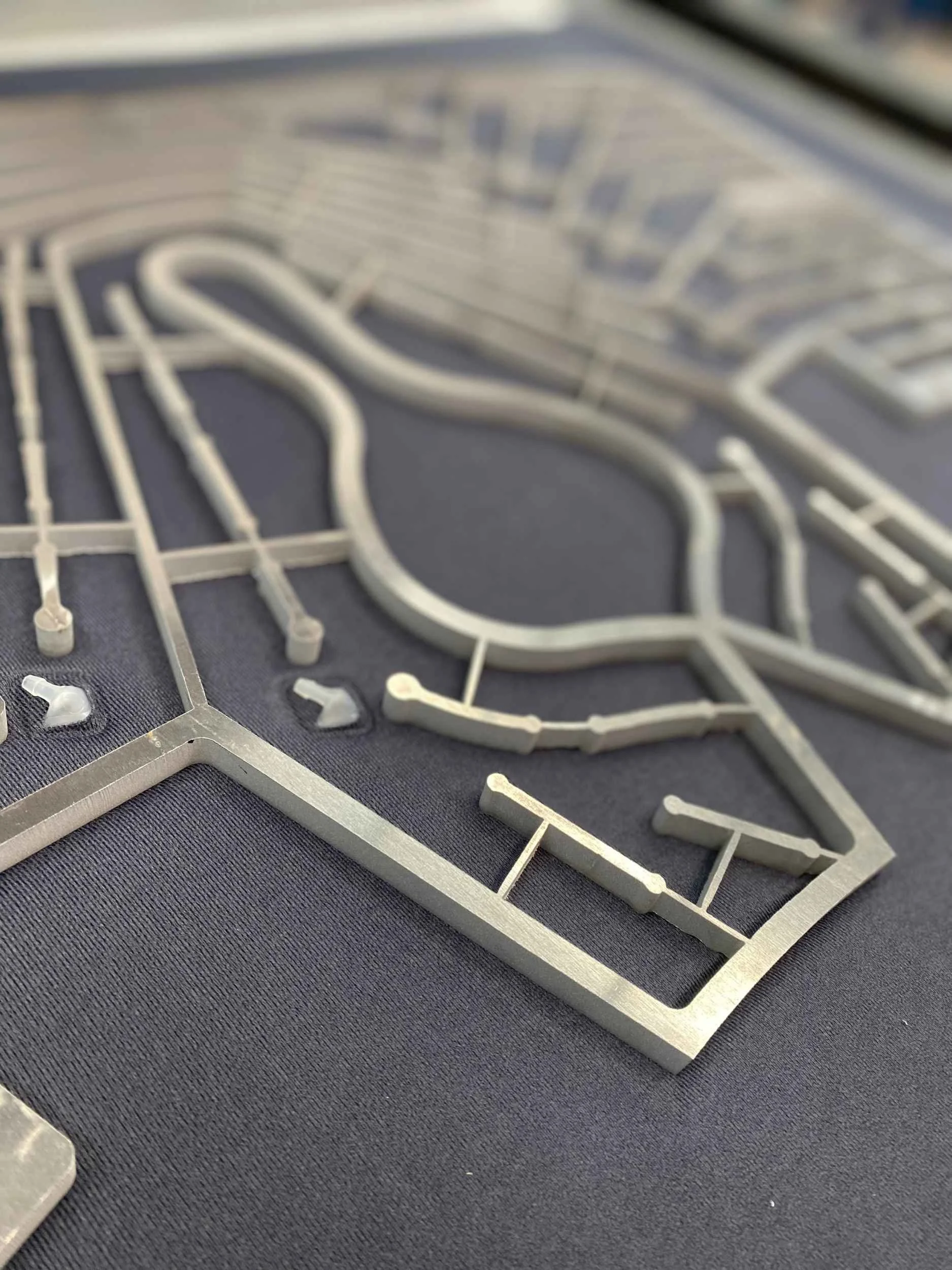 Close-up of a gray plastic model kit piece on a black surface.