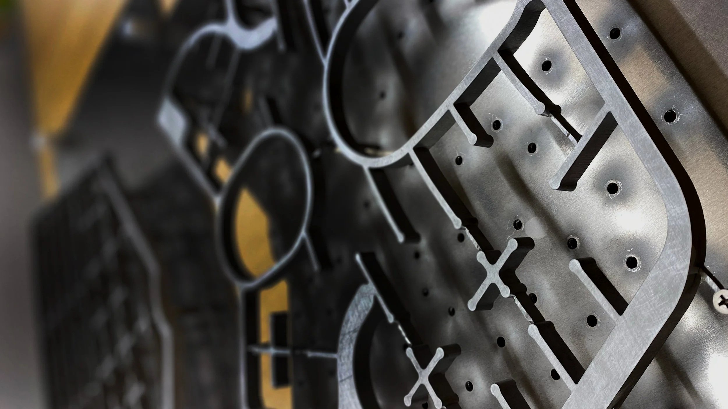 Close-up image of a metallic engine block with detailed machined parts and mounting holes.