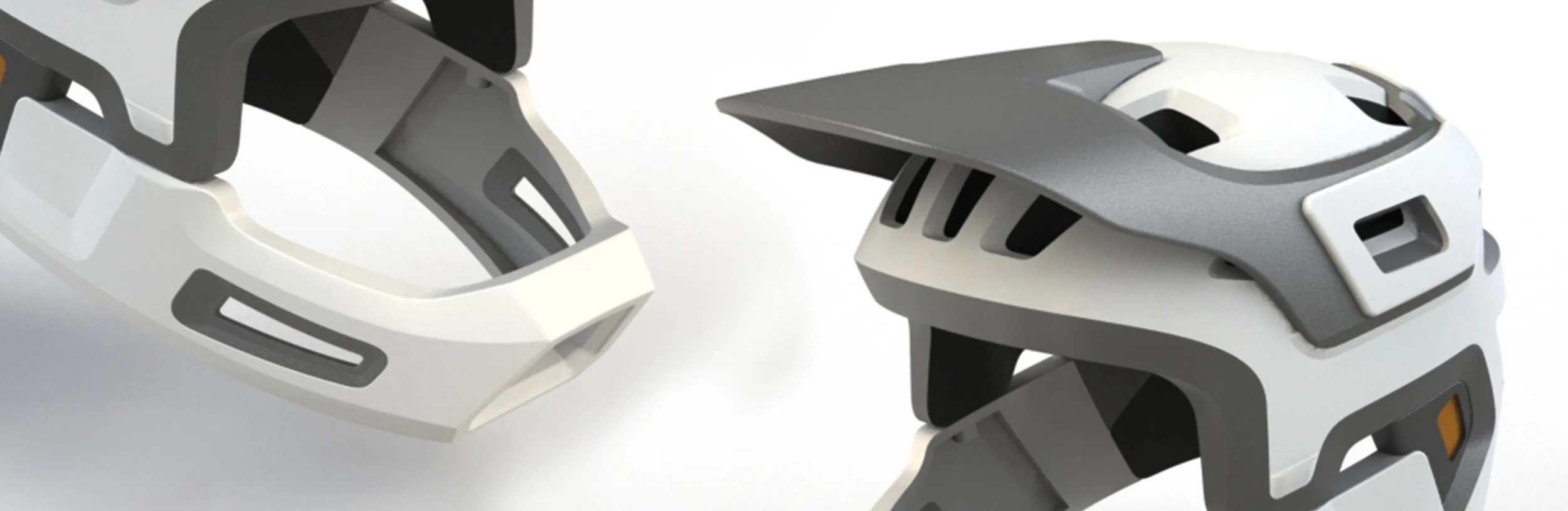 A pair of modern white and gray ski or snowboard helmets with elongated ventilation slots.