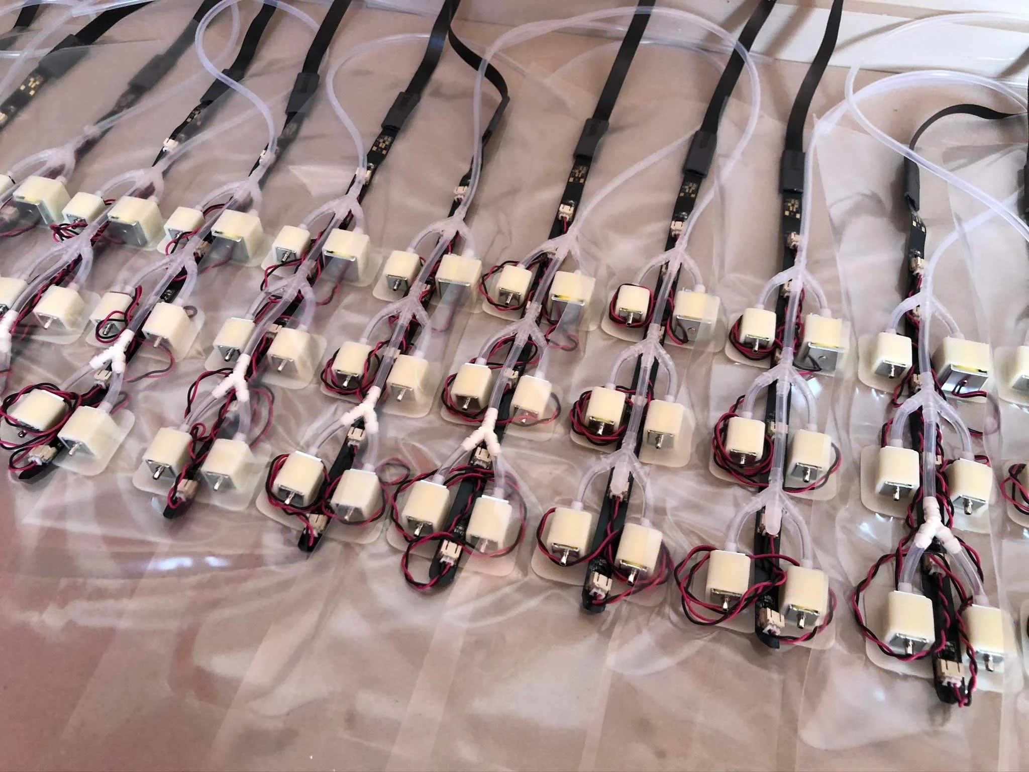 Multiple small electrical motors connected with wires on a table