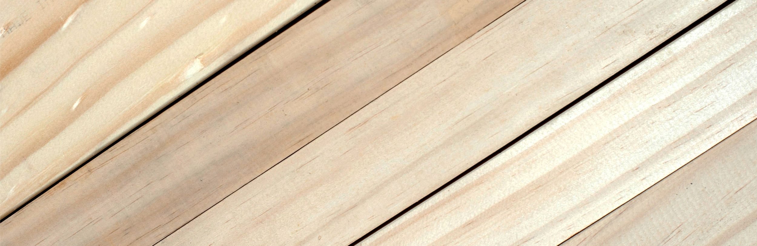 Close-up of light-colored wooden planks with visible grain.