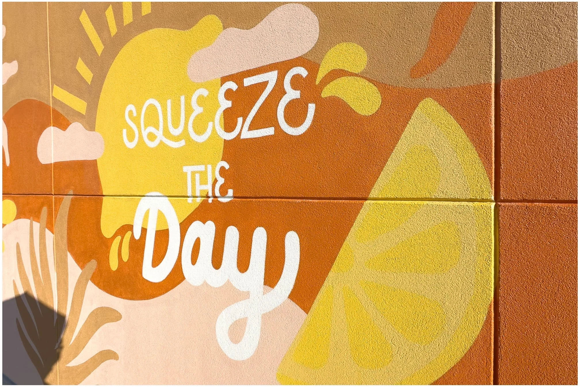 Angled view of First Watch exterior mural — vibrant orange and white palette, hand-painted