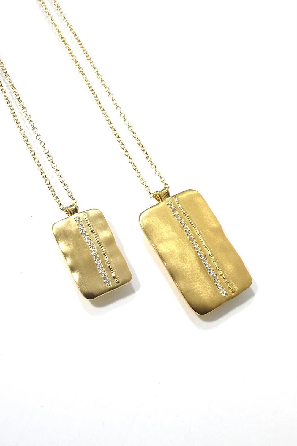 Pair of gold necklaces with rectangular pendants, each featuring a vertical row of small diamonds.