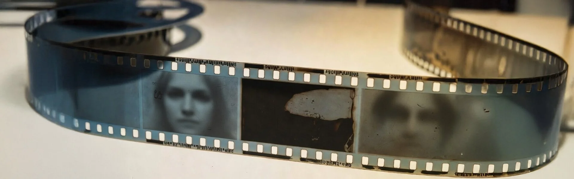 Vintage 35mm film strip: every splice, scratch, and mark preserved. The raw original – no hidden edits or auto-smoothing.