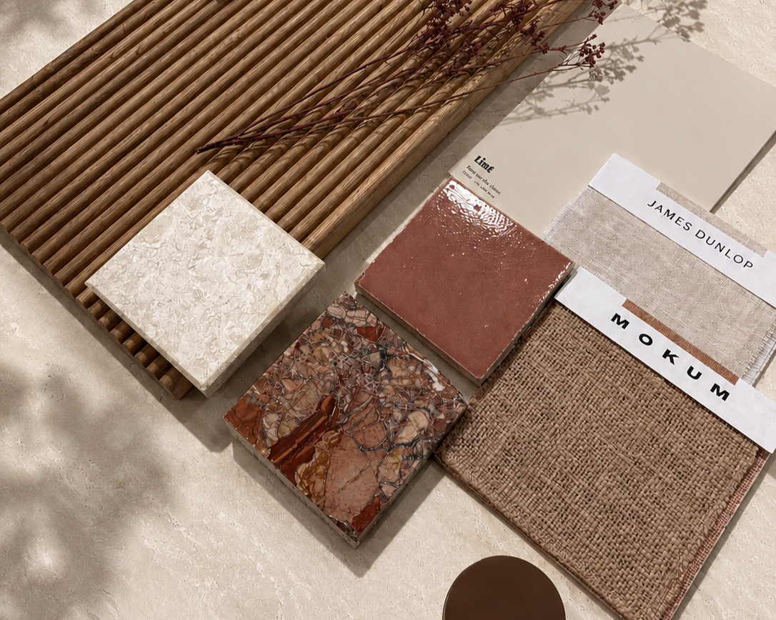 Warm material palette of terracotta tile, red marble, ribbed timber panel and woven fabric samples