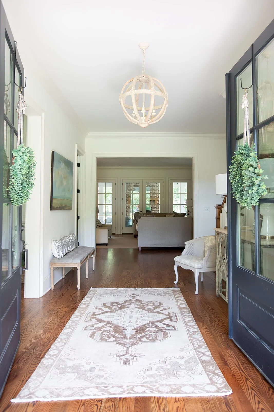 Entry Way with an ornate rug and a bench