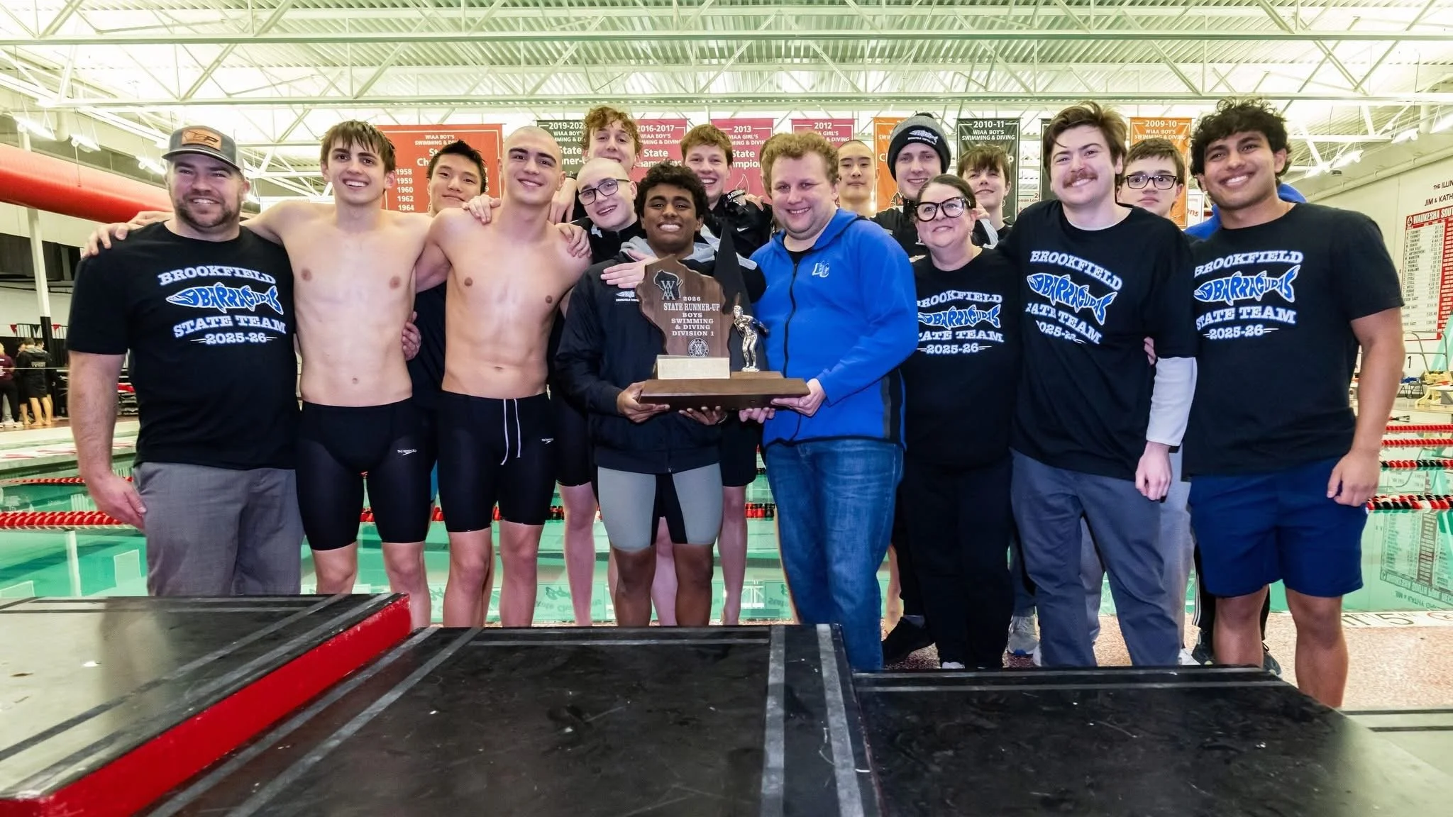 Boys Swim holding runner up trophy