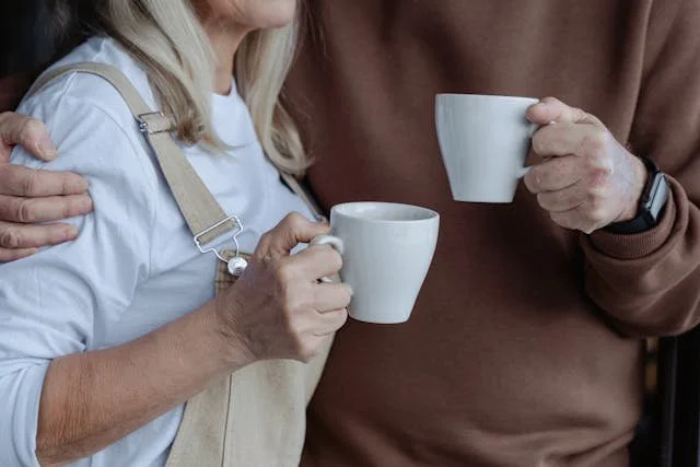 couple holding coffee mugs