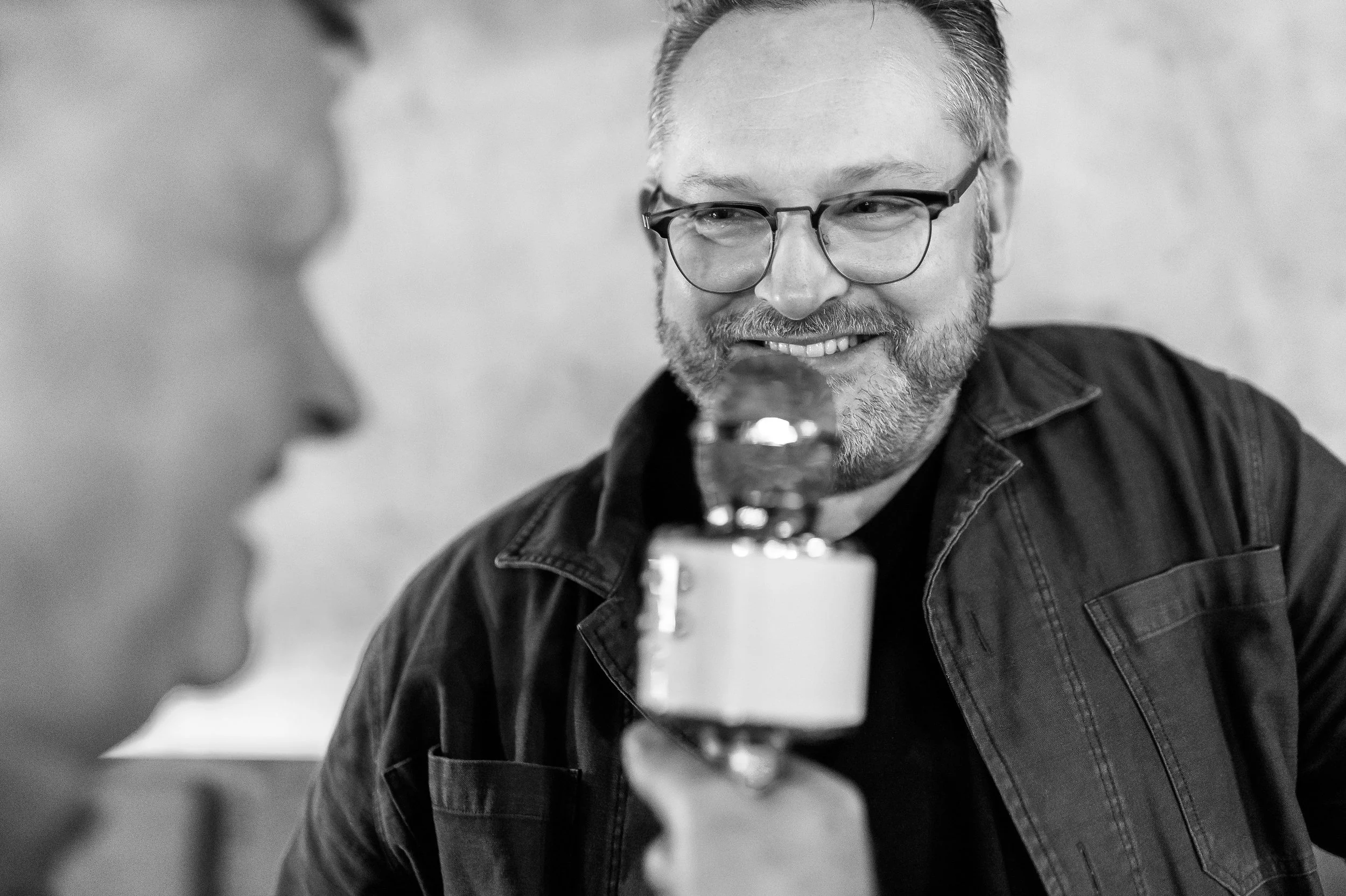 Dave Hackney singing with microphone at SAM Christmas party