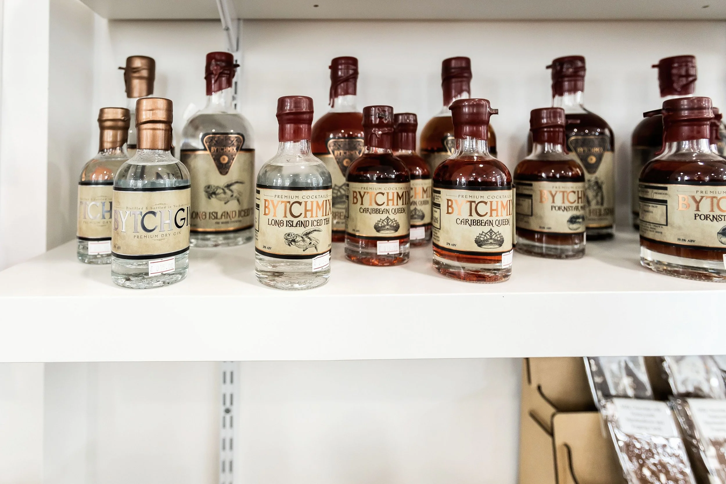 Wax-sealed bottles of Yorkshire gin and cocktails on a shop shelf