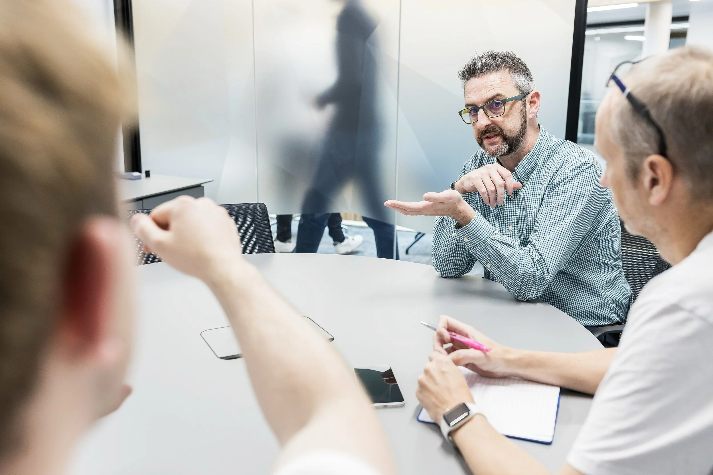 Documentary-style corporate photography in Leeds boardroom small group setting
