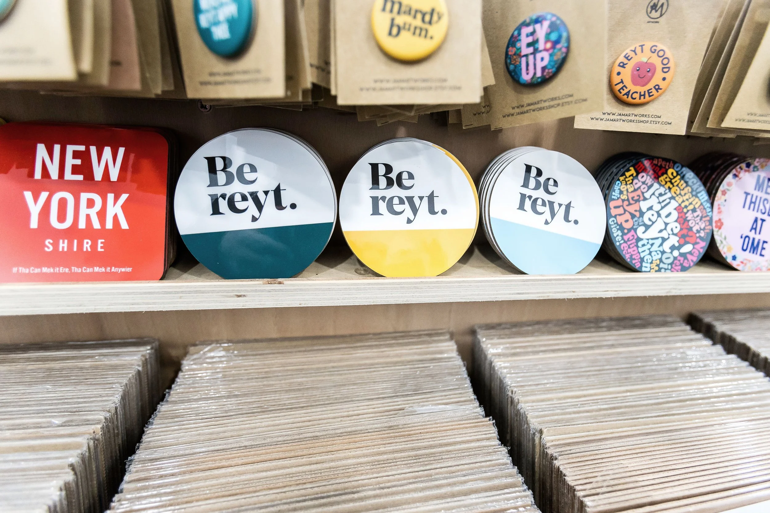 Yorkshire slang coasters and badges reading "Be reyt", "Ey up" and "mardy bum"
