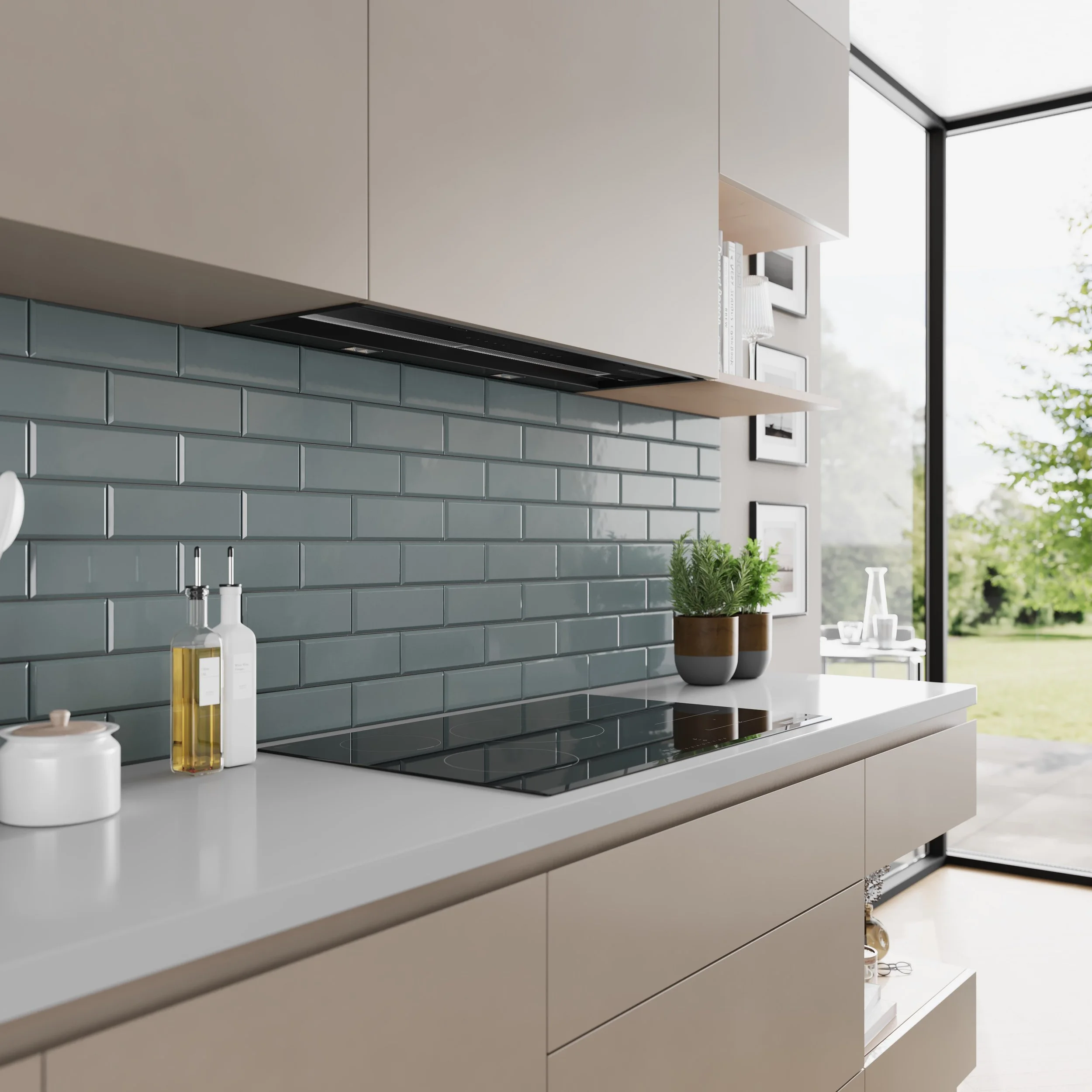 Bosch hob shown in situ with beige cabinets, blue subway tile backsplash, and a white countertop. There are bottles of oil and a white jar on the counter, and a pair of potted plants with green foliage on the right side.