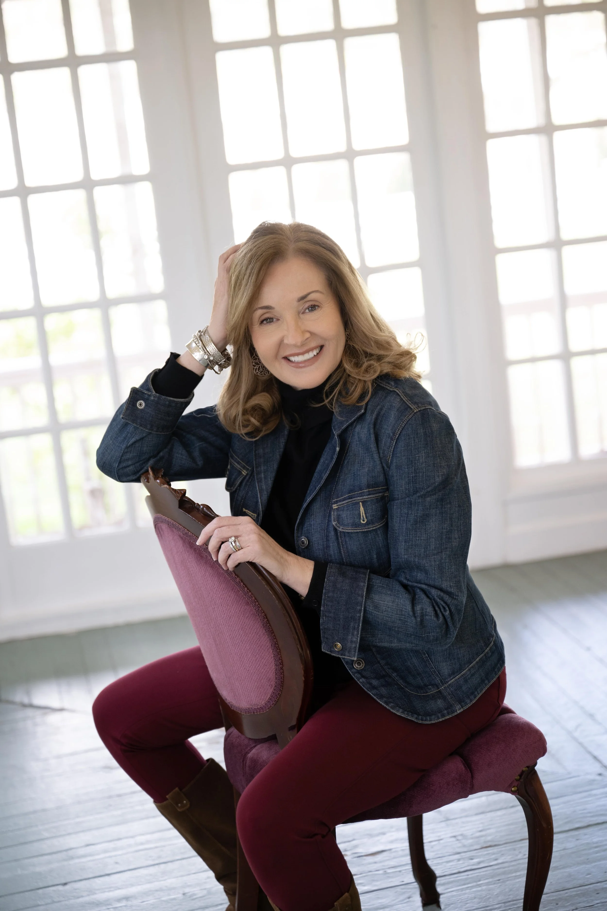 Woman in chair in available light studio headshot portraits