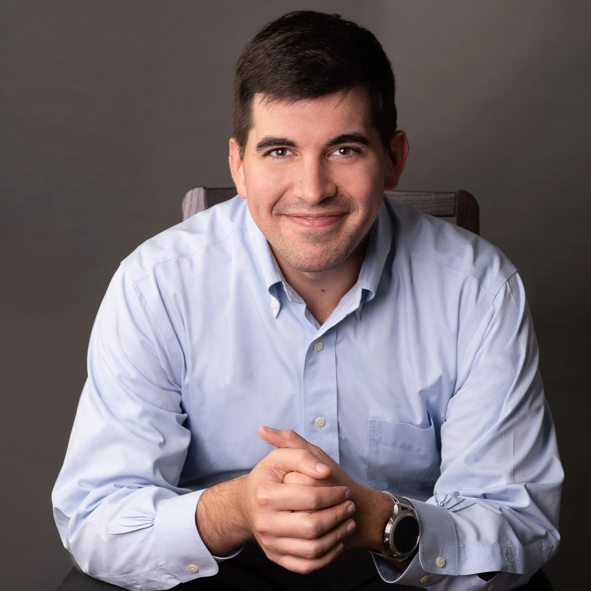 Man seated pro headshots by Rinat Halon Winter Park Photographer