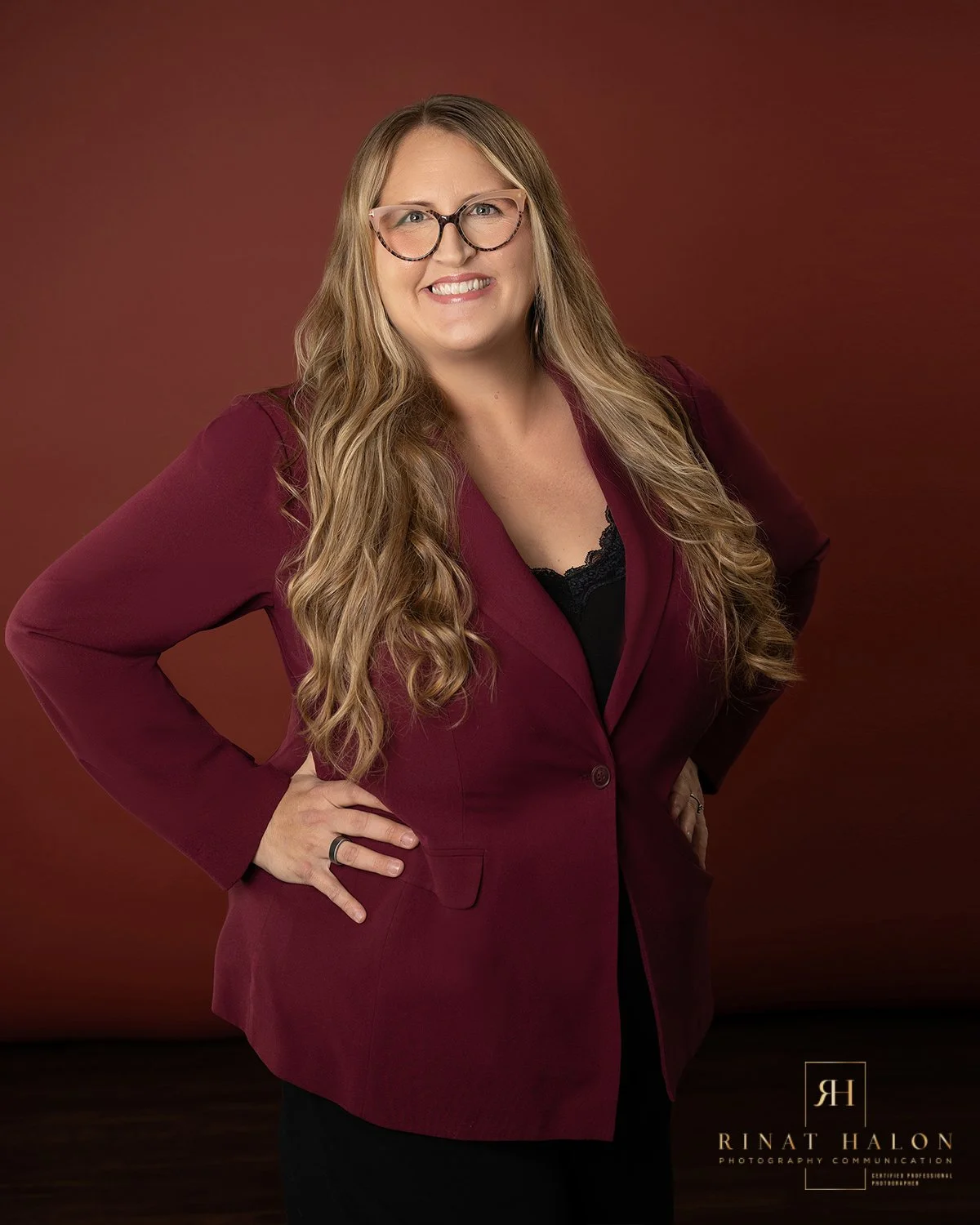 Woman with long blonde hair and a burgundy jacket posing for branding photography in Winter Park GL FL