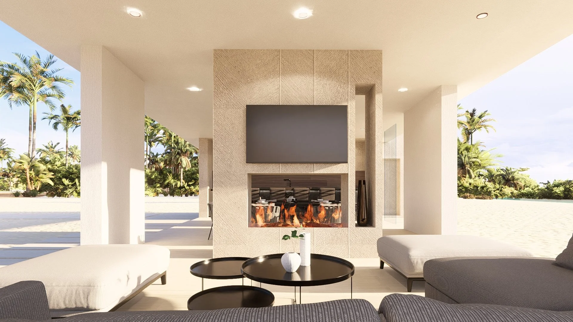Modern modular, hurricane resistant steel frame Bauhu living room with beige walls, a fireplace, a large flat-screen TV, gray couches, black coffee tables with vases, and outdoor scenery of palm trees and blue sky.