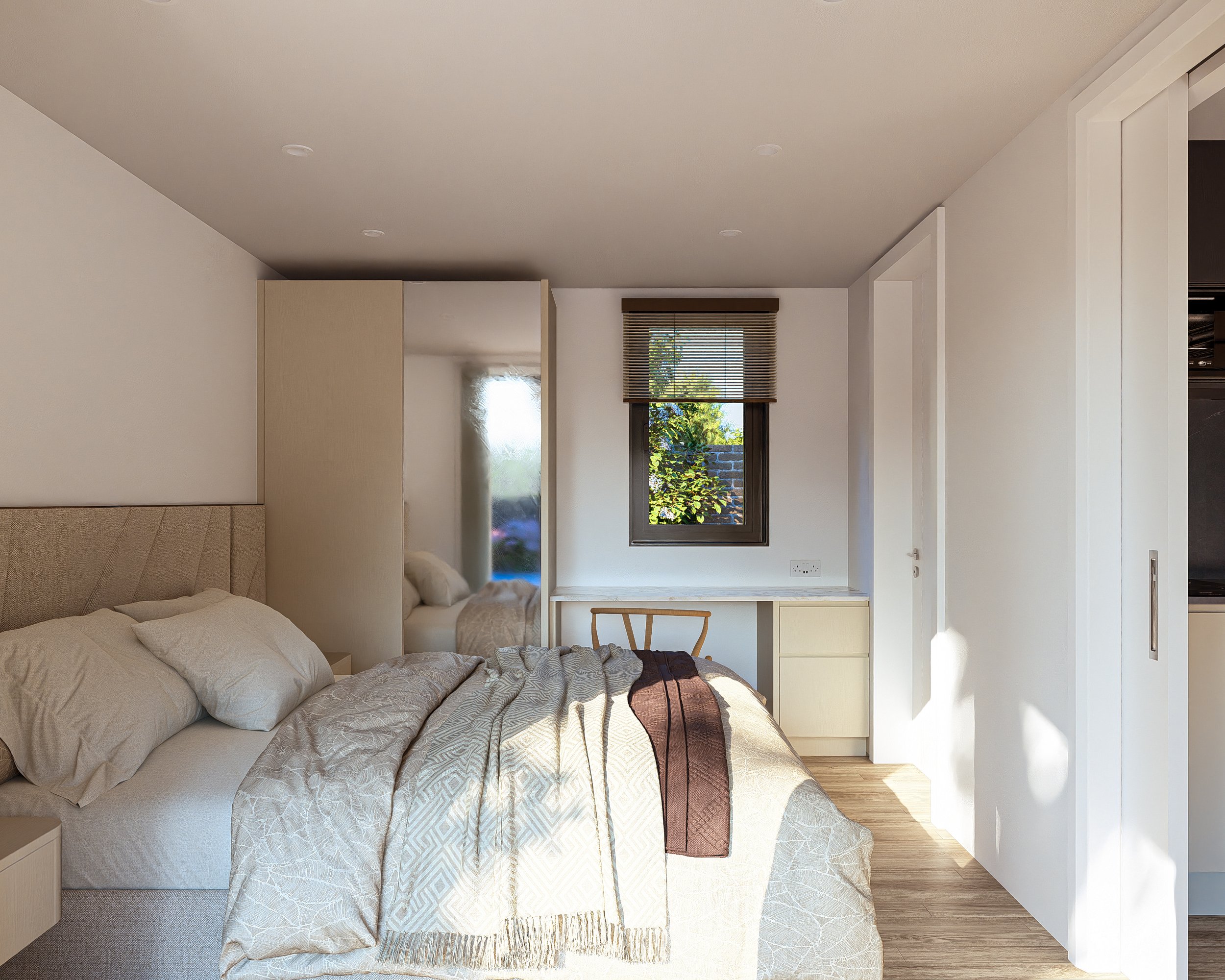 A modern Bauhu hurricane resistant modular home bedroom with a bed, beige headboard, and linen bedding, a small desk under a window with blinds, and natural sunlight.